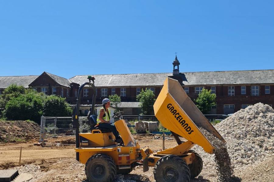 Forward tipping dumper discharging a load on a construction site