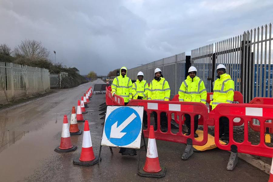 Streetworks gang setting out signing, lighting and guarding